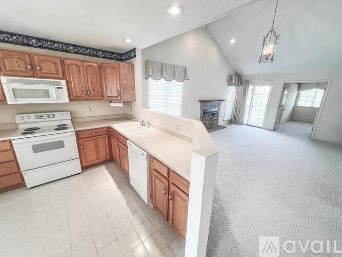 A kitchen with wooden cabinets and white appliances.