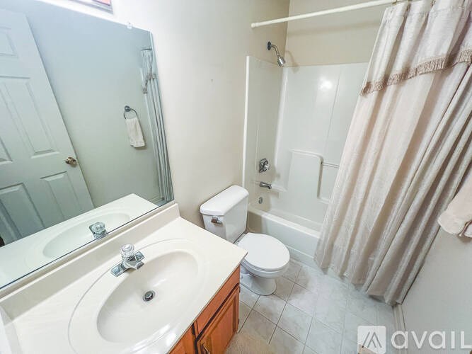 A bathroom with a sink, toilet, and shower.
