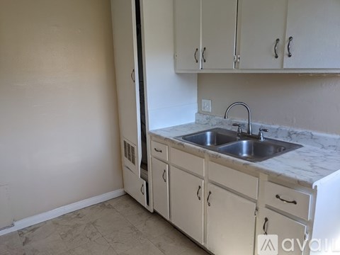 A kitchen with a sink and cabinets.