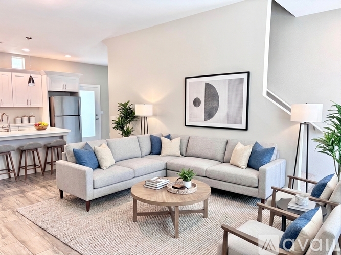 A spacious room with a door, two windows, and tiled flooring.