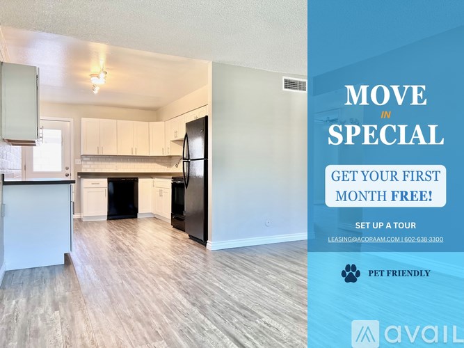 A room with a kitchen area and a sign offering a free first month.