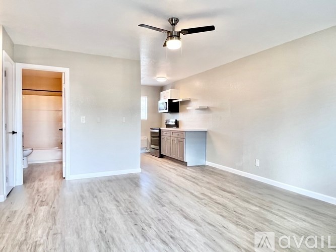 A room with a ceiling fan and a cabinet.