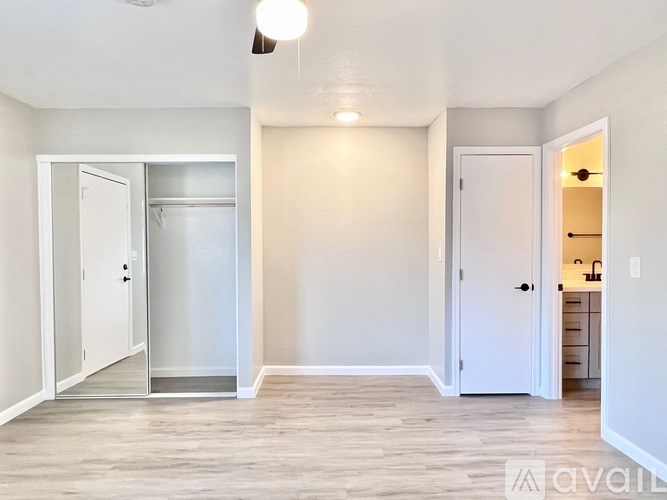 A room with a white door and a white wall.