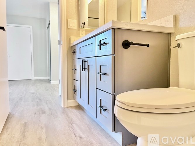 A bathroom with a toilet, sink, and medicine cabinet.