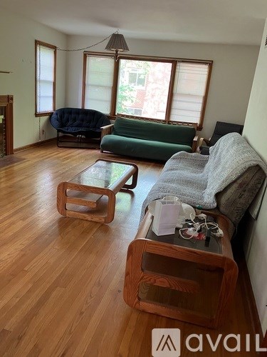 A living room with a green couch and a wooden coffee table.