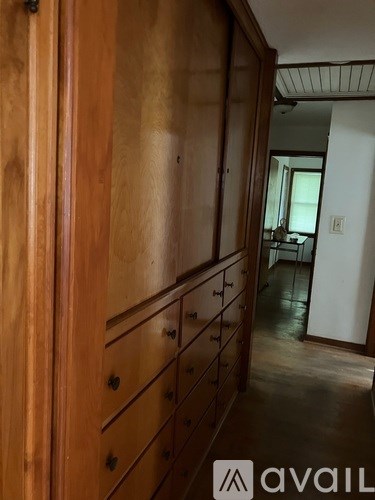 A room with wooden furniture and a logo that says "avaiL".