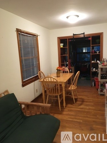 A room with a table and chairs in it.