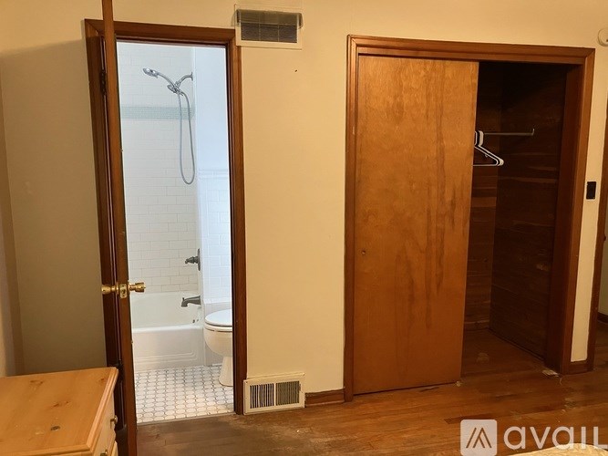 A room with a toilet and a shower.