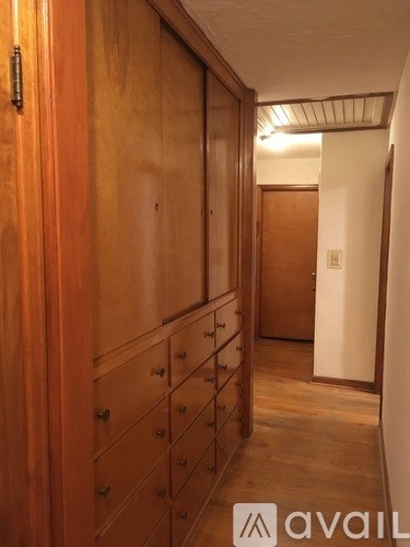 A hallway with wooden doors and drawers.