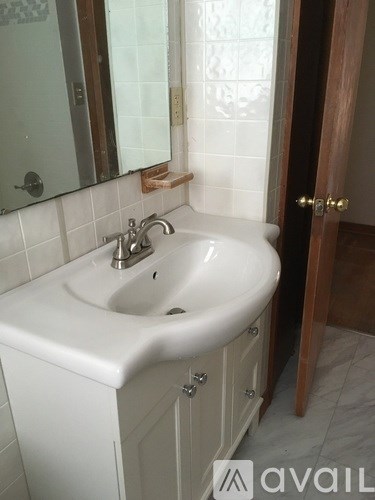 A white sink with a silver faucet in a bathroom.