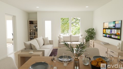A modern living room with a dining table set for two.
