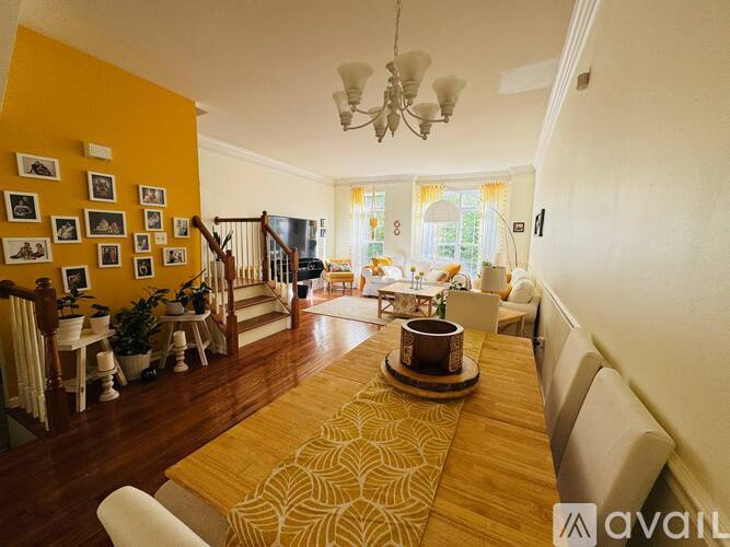 A dining room with a long table and chairs.