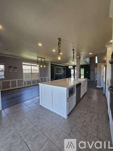 A kitchen with a large island in the middle.