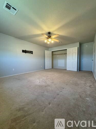 A room with a ceiling fan and a light fixture.
