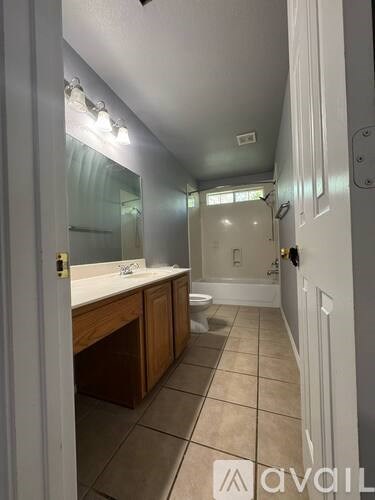 A bathroom with a toilet, sink, and bathtub.