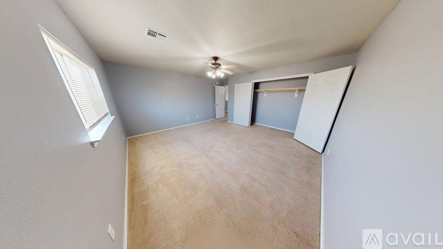 A room with grey walls and carpeted floor.