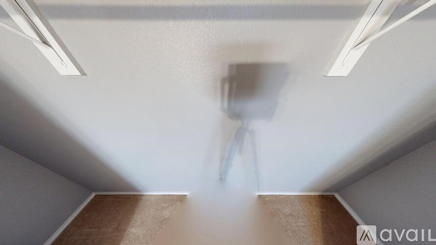 A white door is in a black hallway.