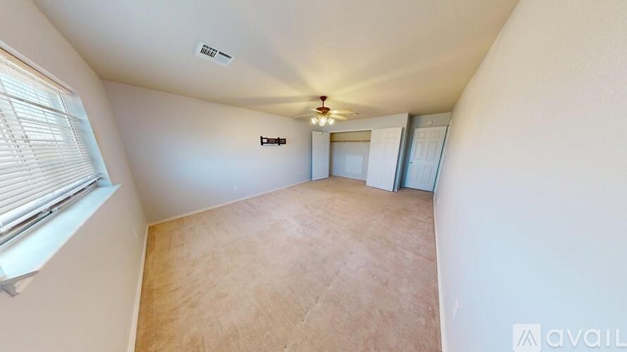 A backyard with a wooden deck and a fence.