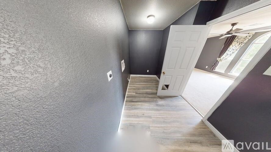 A room with a ceiling fan and a light fixture.