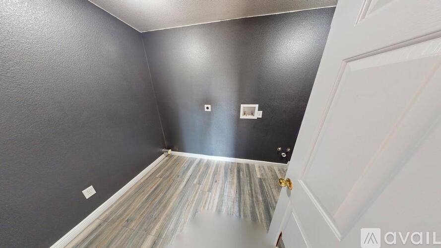 A spacious room with a ceiling fan and carpeted floor.