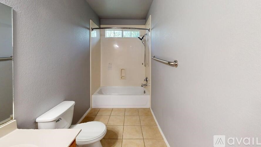 A bathroom with a toilet, sink, and bathtub.