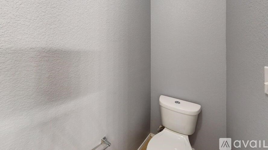 A white toilet in a small bathroom.