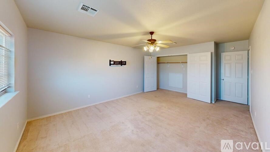 A room with a ceiling fan and a light fixture.
