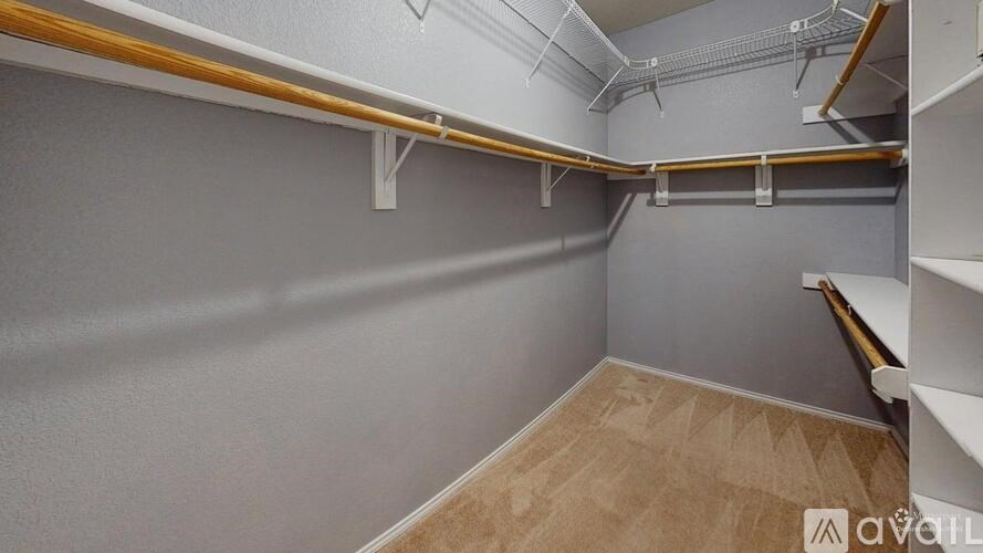 A storage room with shelves and a carpeted floor.
