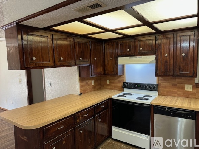 A spacious room with a ceiling fan and a window with blinds.