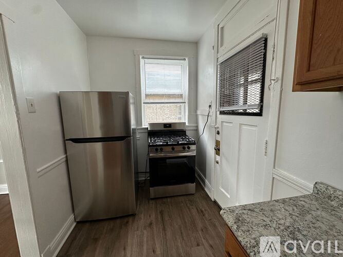A kitchen with a stainless steel refrigerator and stove.