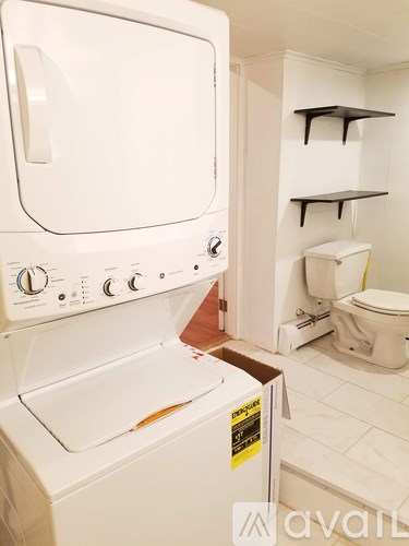 A white dishwasher and washing machine in a small kitchen.
