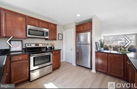 A kitchen with wooden cabinets and stainless steel appliances is available on the market.