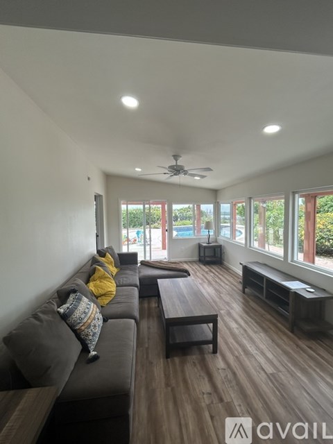 A living room with a grey couch and a wooden table.