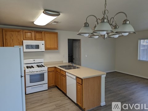 A kitchen with wooden cabinets and a white refrigerator.