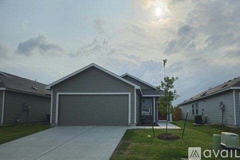 A house with a garage and a driveway is available for sale.