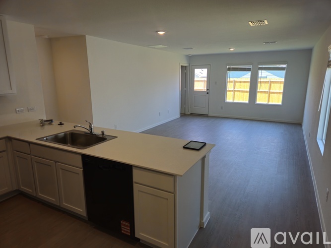 A kitchen with a sink and a window.