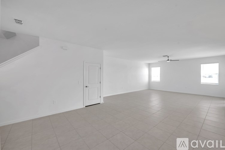 A spacious room with a door and a window.