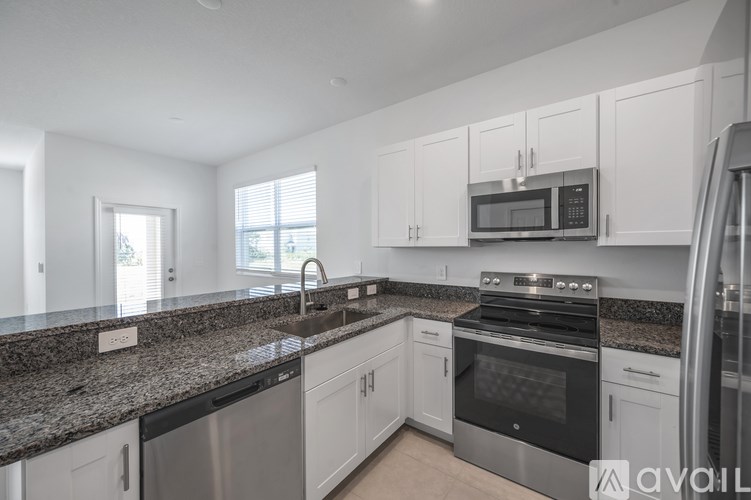 A kitchen with granite countertops and stainless steel appliances.