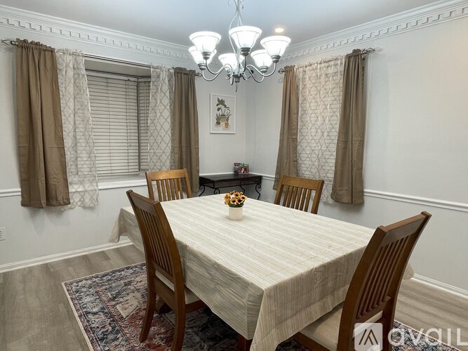 A dining room with a table set for four.