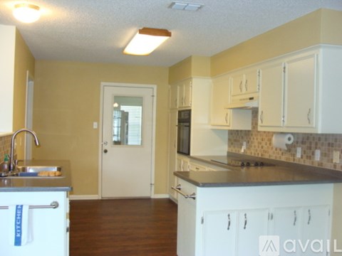 A kitchen with white cabinets and a countertop.