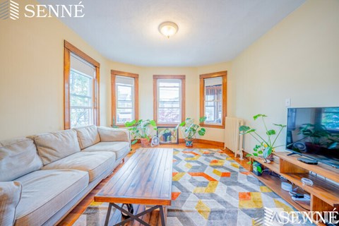 A living room with a large couch and a television.