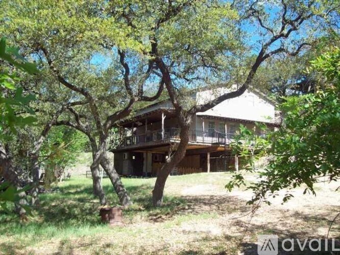 A house is surrounded by trees and grass.