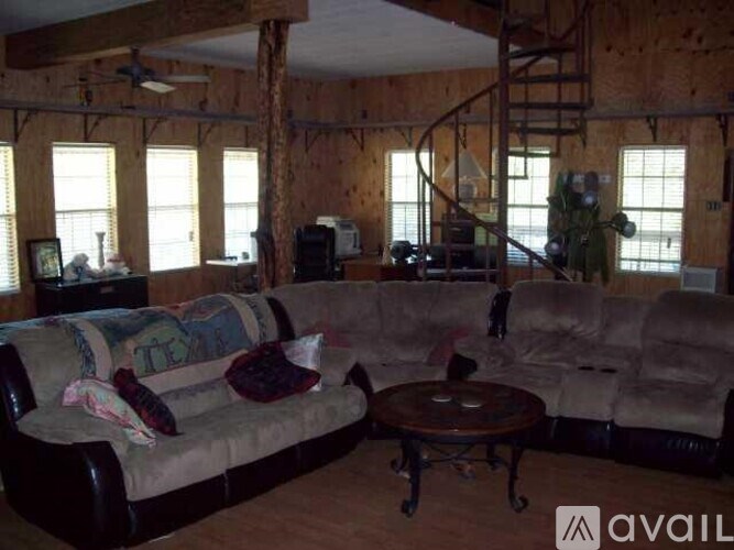 A living room with a couch, a coffee table, and a TV.
