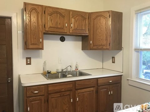 A kitchen with wooden cabinets and a white countertop.