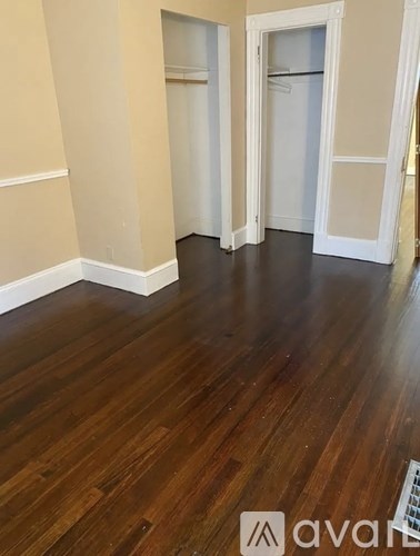 A room with wooden floors and white walls.