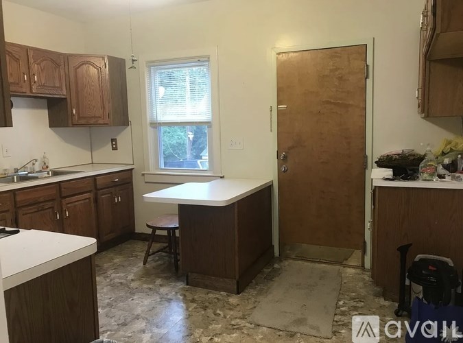 A kitchen with wooden cabinets and a white countertop.