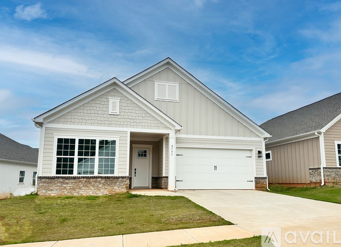 A two-story house with a garage is available for sale.