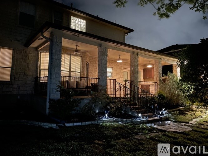 A house with a porch and a lit up staircase.