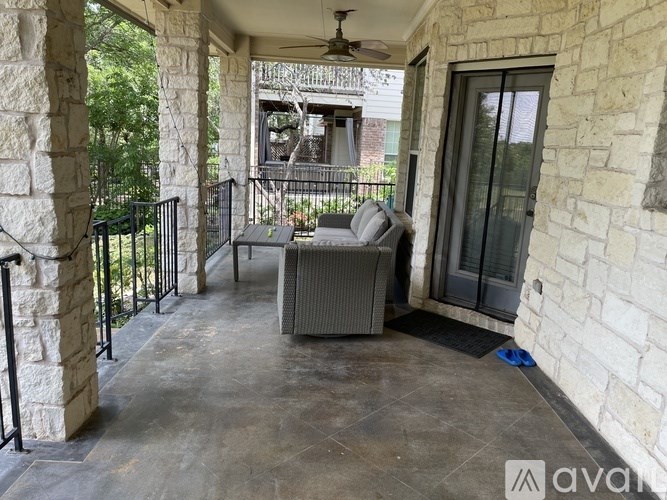 A patio with a couch and a table.