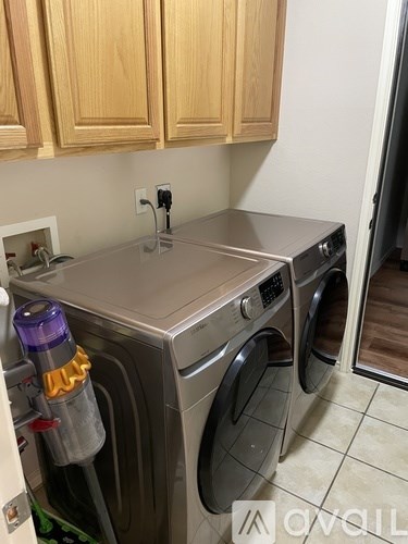A washer and dryer are in a small laundry room.